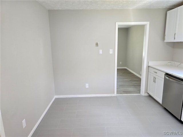 5102 Randall Ave, Henrico, VA 23231 - kitchen with stainless steel dishwasher, white cabinetry, and light countertops