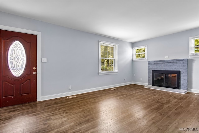 2803 Drewrys Bluff Rd, Chesterfield, VA 23237 - unfurnished living room with plenty of natural light, wood finished floors, and a brick fireplace