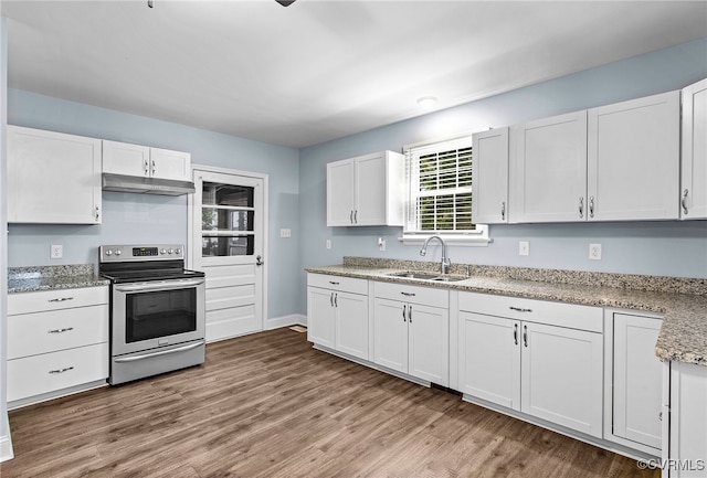 2803 Drewrys Bluff Rd, Chesterfield, VA 23237 - kitchen featuring stainless steel electric range oven, under cabinet range hood, wood finished floors, white cabinetry, and light stone countertops