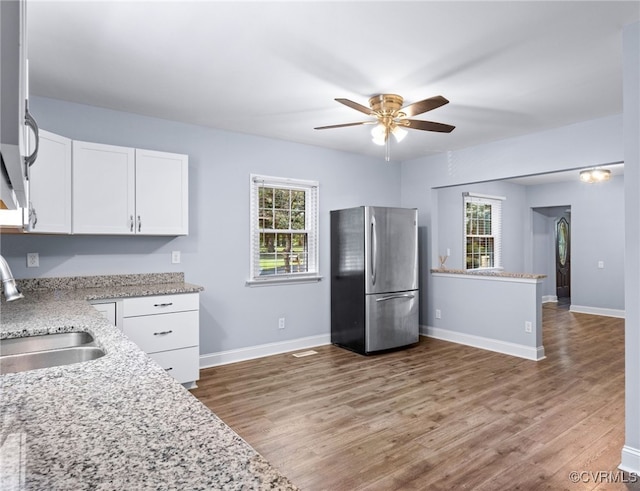 2803 Drewrys Bluff Rd, Chesterfield, VA 23237 - kitchen featuring freestanding refrigerator, ceiling fan, white cabinetry, wood finished floors, and light stone countertops