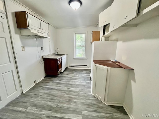 3207 Tuxedo Blvd, Richmond, VA 23223 - kitchen with a baseboard heating unit, wood finished floors, and white cabinets
