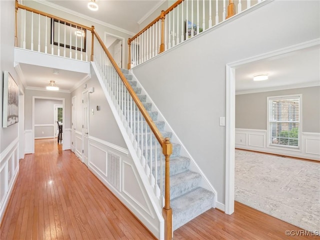 13625 Brandy Oaks Rd, Chesterfield, VA 23832 - staircase with crown molding, wood-type flooring, a decorative wall, and wainscoting