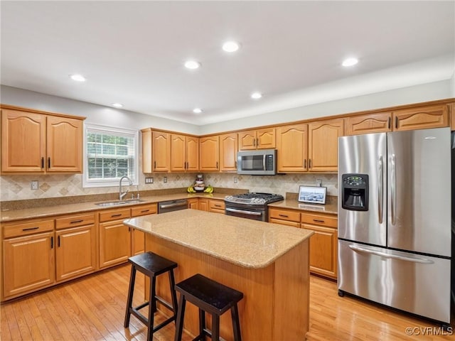 13625 Brandy Oaks Rd, Chesterfield, VA 23832 - kitchen with stainless steel appliances, a kitchen breakfast bar, a kitchen island, light wood-style floors, and recessed lighting