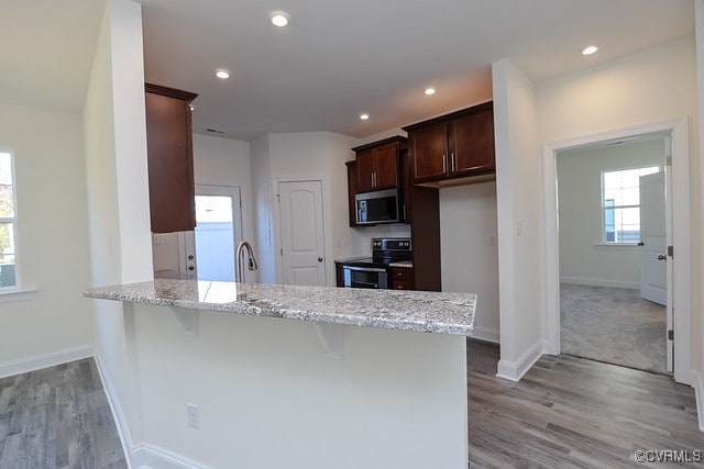 6401 Belay Dr, Chesterfield, VA 23234 - kitchen with appliances with stainless steel finishes, a peninsula, light wood-type flooring, light stone counters, and recessed lighting