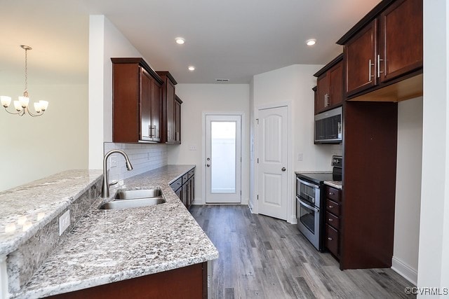 6401 Belay Dr, Chesterfield, VA 23234 - kitchen with stainless steel appliances, a chandelier, wood finished floors, a peninsula, and tasteful backsplash