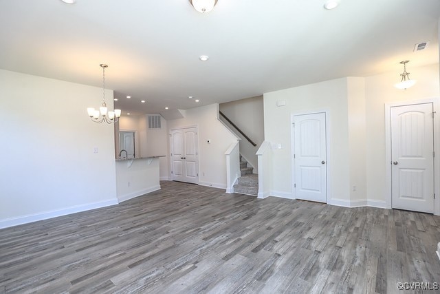 6401 Belay Dr, Chesterfield, VA 23234 - unfurnished living room featuring wood finished floors, stairs, a chandelier, and recessed lighting