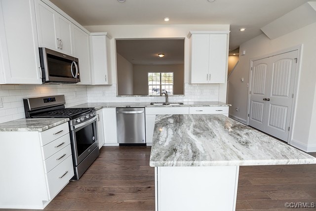 6419 Belay Dr, Chesterfield, VA 23234 - kitchen featuring appliances with stainless steel finishes, a kitchen island, light stone counters, dark wood-style floors, and recessed lighting