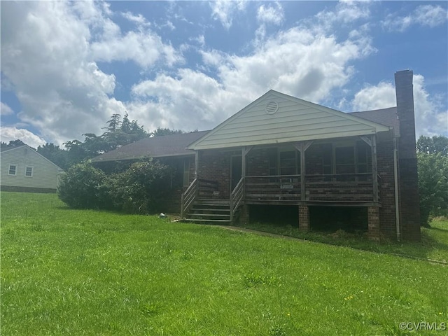 1290 Grapevine Rd, Henrico, VA 23150 - view of front of property with covered porch, a front yard, brick siding, and a chimney