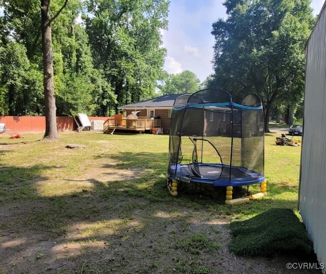 5946 Swanson Rd, Richmond, VA 23225 - view of yard featuring a trampoline and a wooden deck