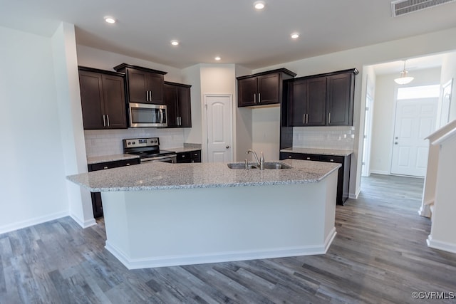 6413 Belay Dr, Chesterfield, VA 23234 - kitchen with stainless steel appliances, dark brown cabinetry, backsplash, an island with sink, and recessed lighting