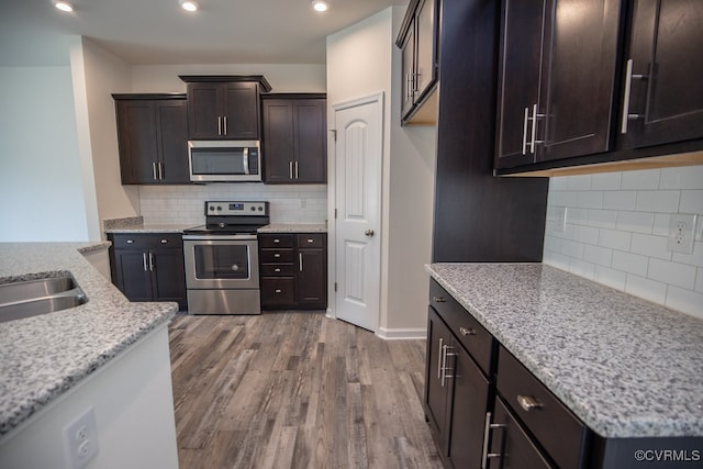 6413 Belay Dr, Chesterfield, VA 23234 - kitchen featuring appliances with stainless steel finishes, tasteful backsplash, dark wood finished floors, dark brown cabinets, and recessed lighting