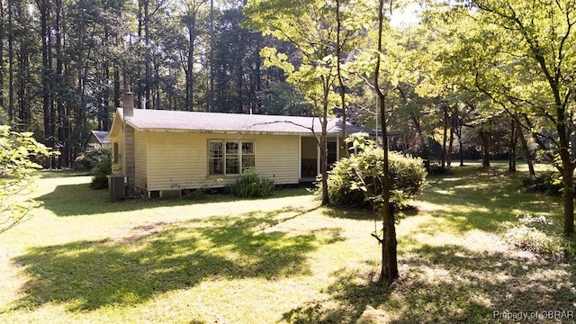 1026 Hoecake Rd, Lancaster, VA 22513 - view of front of property featuring a front lawn, a chimney, and a forest view