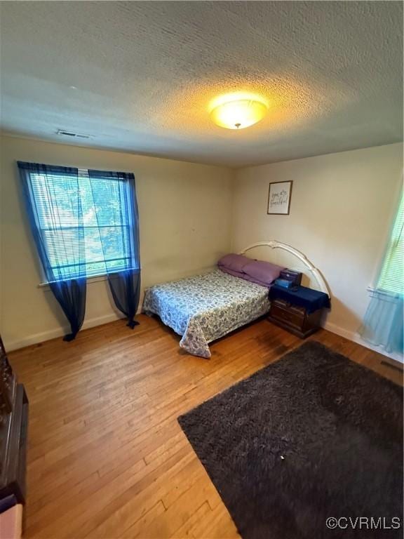 305 Danray Dr, Henrico, VA 23227 - bedroom with a textured ceiling and wood finished floors