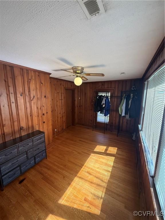 305 Danray Dr, Henrico, VA 23227 - empty room featuring wood finished floors, a textured ceiling, ceiling fan, and wood walls