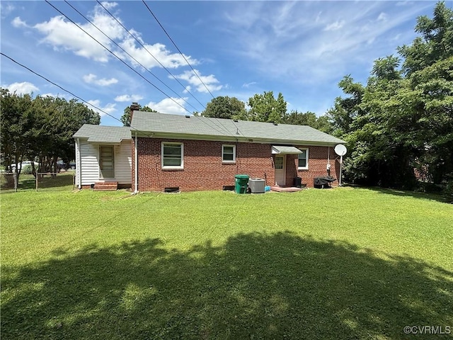 305 Danray Dr, Henrico, VA 23227 - rear view of house featuring entry steps, a yard, brick siding, and a chimney
