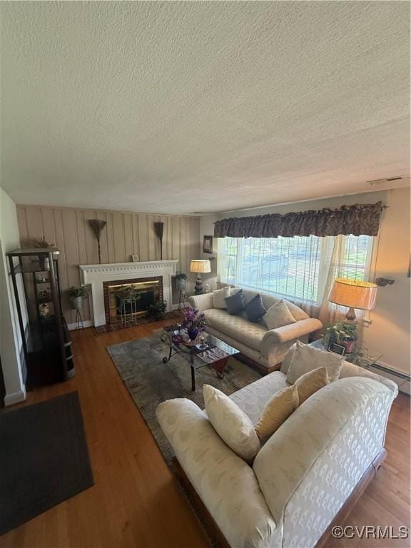 305 Danray Dr, Henrico, VA 23227 - living room with a textured ceiling, wood finished floors, and a fireplace with flush hearth