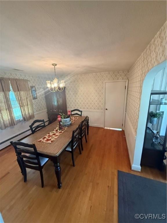 305 Danray Dr, Henrico, VA 23227 - dining room with wallpapered walls, wood finished floors, a chandelier, and arched walkways