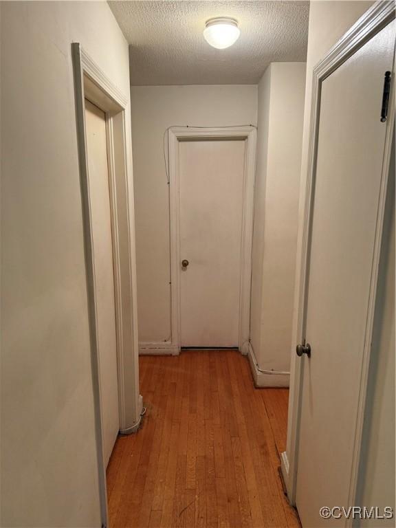 305 Danray Dr, Henrico, VA 23227 - hallway with light wood-type flooring and a textured ceiling
