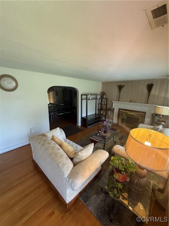 305 Danray Dr, Henrico, VA 23227 - living room featuring arched walkways, wood finished floors, and a fireplace