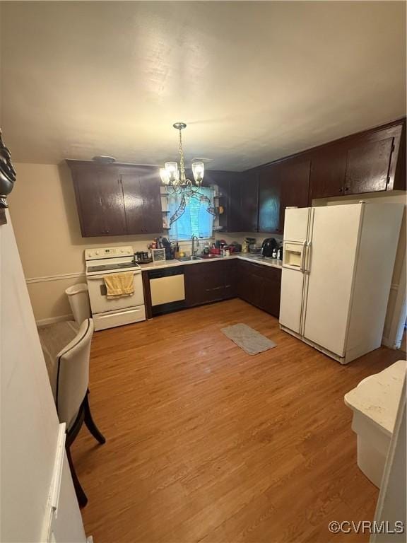 305 Danray Dr, Henrico, VA 23227 - kitchen featuring white appliances, light wood-type flooring, light countertops, a chandelier, and dark brown cabinetry