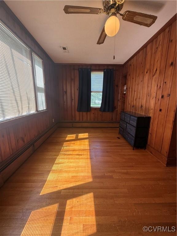 305 Danray Dr, Henrico, VA 23227 - unfurnished room with wood finished floors, plenty of natural light, wood walls, and ceiling fan