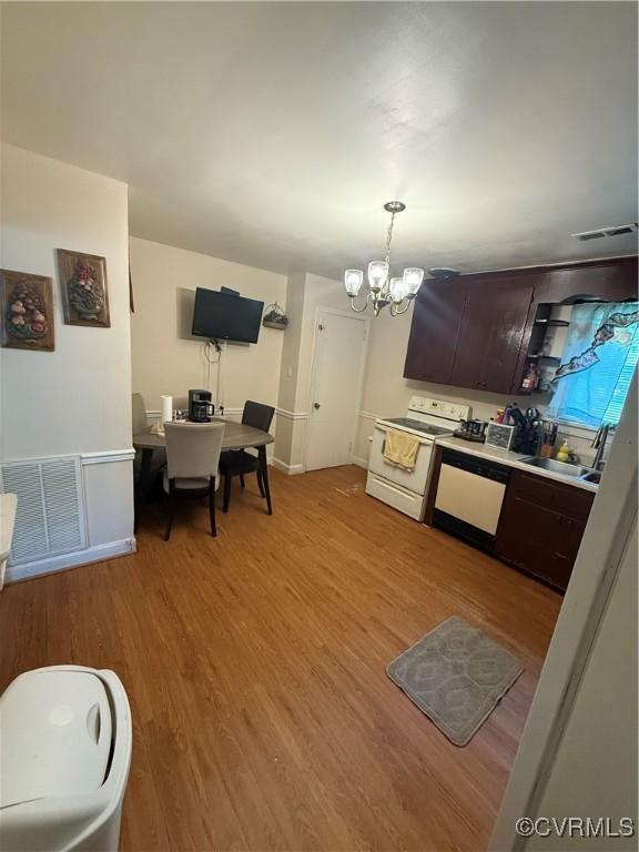 305 Danray Dr, Henrico, VA 23227 - kitchen with white appliances, a chandelier, dark brown cabinets, light wood finished floors, and pendant lighting