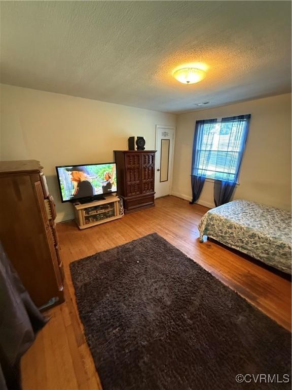 305 Danray Dr, Henrico, VA 23227 - bedroom featuring wood finished floors and a textured ceiling