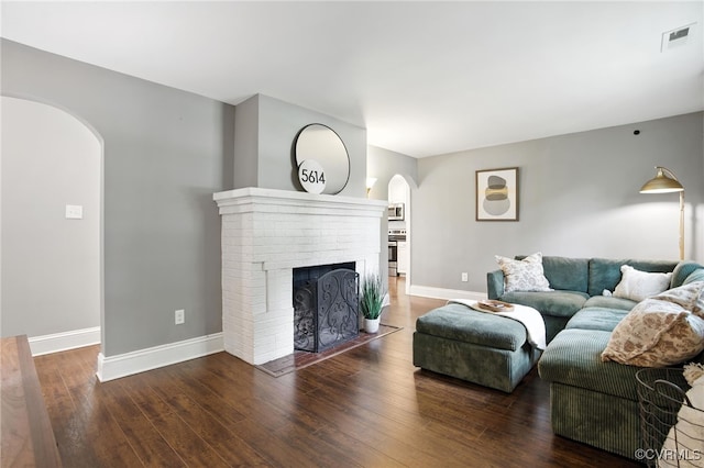 5614 Jahnke Rd, Richmond, VA 23225 - living area with arched walkways, wood-type flooring, and a fireplace