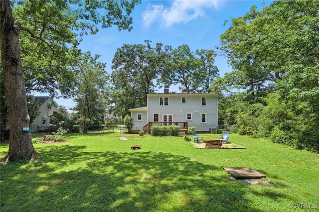 5614 Jahnke Rd, Richmond, VA 23225 - rear view of property with a fire pit, a wooden deck, and a chimney