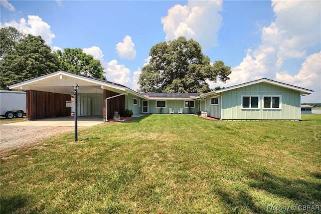 1583 Winona Park Dr, West Point, VA 23181 - ranch-style house with driveway, board and batten siding, roof mounted solar panels, and a front yard