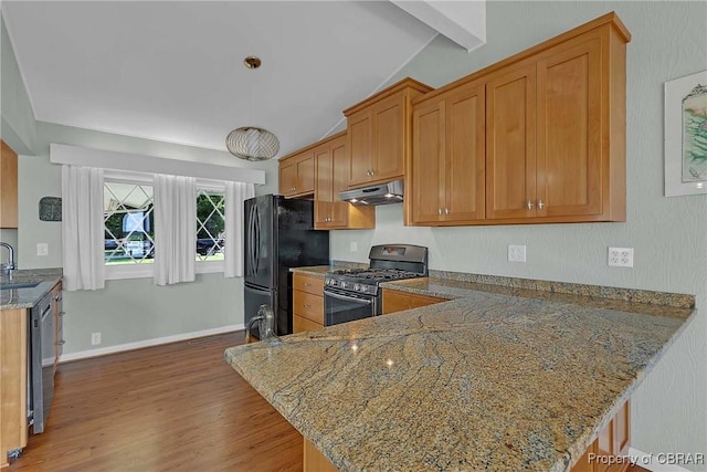 1583 Winona Park Dr, West Point, VA 23181 - kitchen featuring gas stove, freestanding refrigerator, under cabinet range hood, wood finished floors, and a peninsula