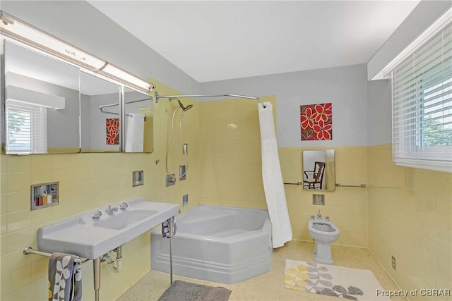 1583 Winona Park Dr, West Point, VA 23181 - full bath with tile walls, shower / bath combo with shower curtain, a bidet, tile patterned flooring, and a wainscoted wall