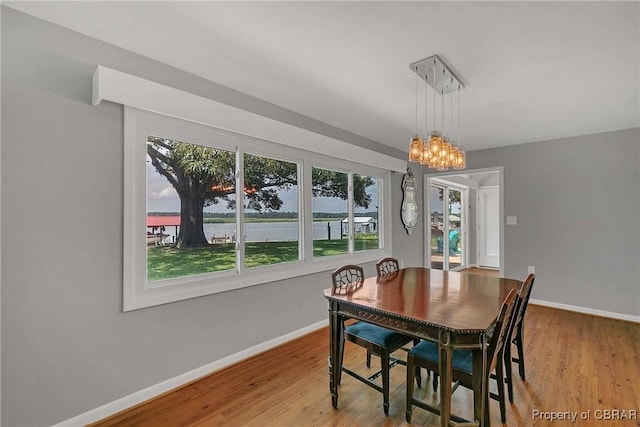 1583 Winona Park Dr, West Point, VA 23181 - dining space with a chandelier, wood finished floors, and a water view