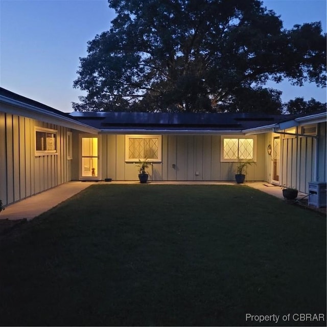 1583 Winona Park Dr, West Point, VA 23181 - back of house at dusk with board and batten siding and solar panels