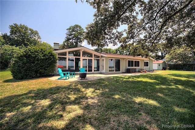 1583 Winona Park Dr, West Point, VA 23181 - back of house with a patio area, a lawn, board and batten siding, a chimney, and an outdoor fire pit