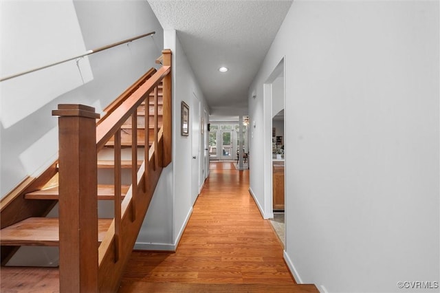 8015 Buford, North Chesterfield, VA 23235 - hallway featuring light wood-type flooring, arched walkways, recessed lighting, stairway, and a textured ceiling