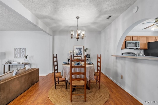 8015 Buford, North Chesterfield, VA 23235 - dining room featuring a textured ceiling, wood finished floors, arched walkways, a chandelier, and a ceiling fan