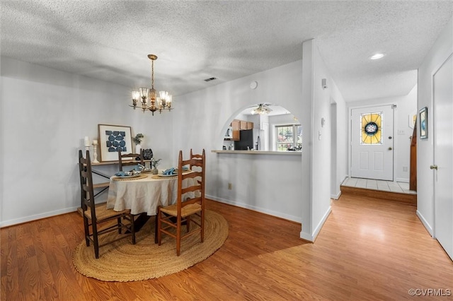 8015 Buford, North Chesterfield, VA 23235 - dining space featuring a textured ceiling, wood finished floors, arched walkways, and a chandelier