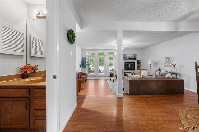 8015 Buford, North Chesterfield, VA 23235 - living area with a glass covered fireplace, wood finished floors, ceiling fan, and a textured ceiling
