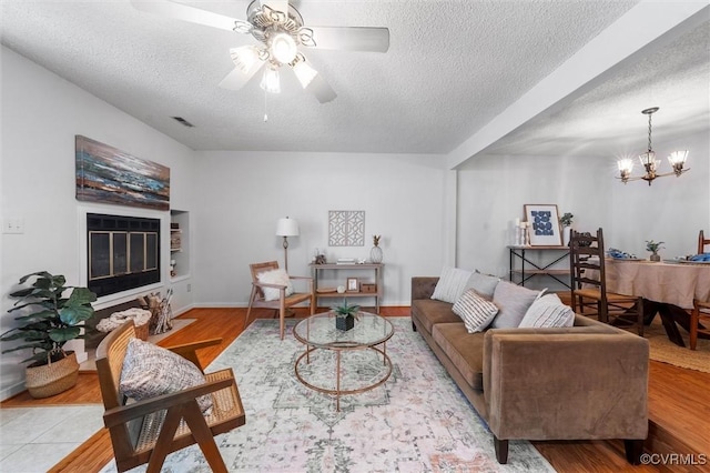 8015 Buford, North Chesterfield, VA 23235 - living room with a textured ceiling, ceiling fan, wood finished floors, and a chandelier