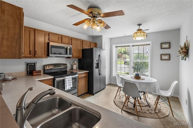 8015 Buford, North Chesterfield, VA 23235 - kitchen featuring brown cabinetry, stainless steel appliances, light countertops, a ceiling fan, and a textured ceiling