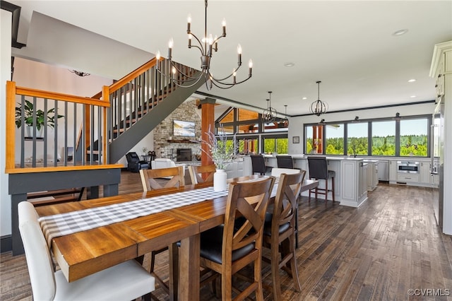 1 Cross County Rd, Mineral, VA 23117 - dining space featuring a chandelier, dark wood finished floors, recessed lighting, a large fireplace, and stairs