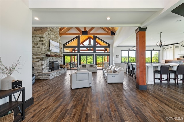 1 Cross County Rd, Mineral, VA 23117 - living area featuring a chandelier, beamed ceiling, dark wood-style flooring, a stone fireplace, and high vaulted ceiling