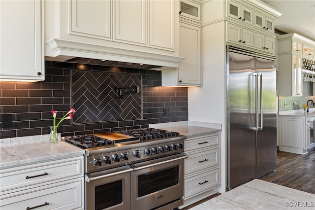 1 Cross County Rd, Mineral, VA 23117 - kitchen featuring premium appliances, backsplash, light stone countertops, glass insert cabinets, and dark wood-style flooring