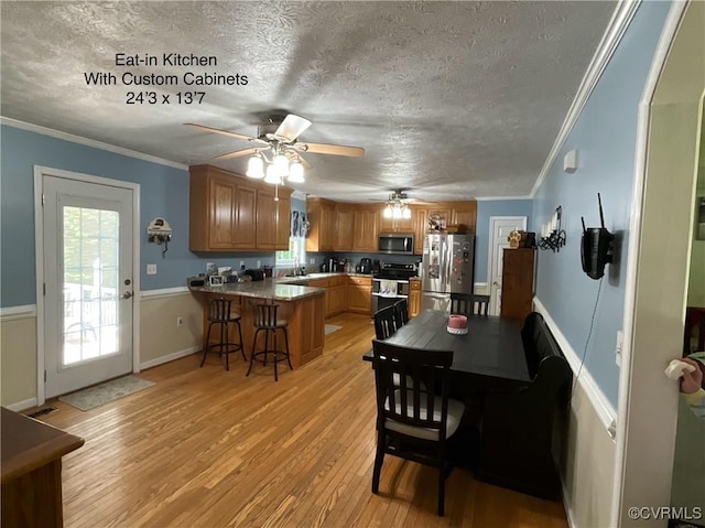 6197 Fishermans Way, Mechanicsville, VA 23116 - dining area featuring light wood finished floors, a ceiling fan, healthy amount of natural light, a textured ceiling, and crown molding