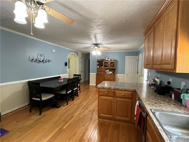 6197 Fishermans Way, Mechanicsville, VA 23116 - kitchen featuring ceiling fan, a peninsula, brown cabinets, arched walkways, and crown molding