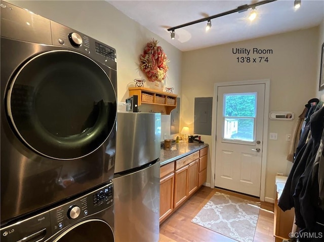 6197 Fishermans Way, Mechanicsville, VA 23116 - laundry area featuring stacked washing machine and dryer, track lighting, light wood finished floors, and electric panel