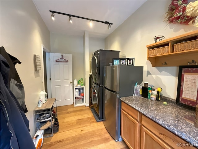 6197 Fishermans Way, Mechanicsville, VA 23116 - kitchen with stacked washer / drying machine, track lighting, freestanding refrigerator, light wood finished floors, and brown cabinets