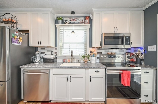 103 N Daisy Ave, Henrico, VA 23075 - kitchen with stainless steel appliances, ornamental molding, white cabinetry, light stone countertops, and decorative light fixtures