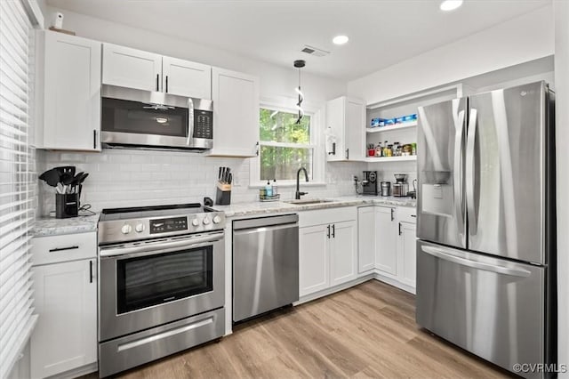 12305 Leesburg Cir, Midlothian, VA 23112 - kitchen featuring appliances with stainless steel finishes, white cabinetry, light wood-style floors, and recessed lighting